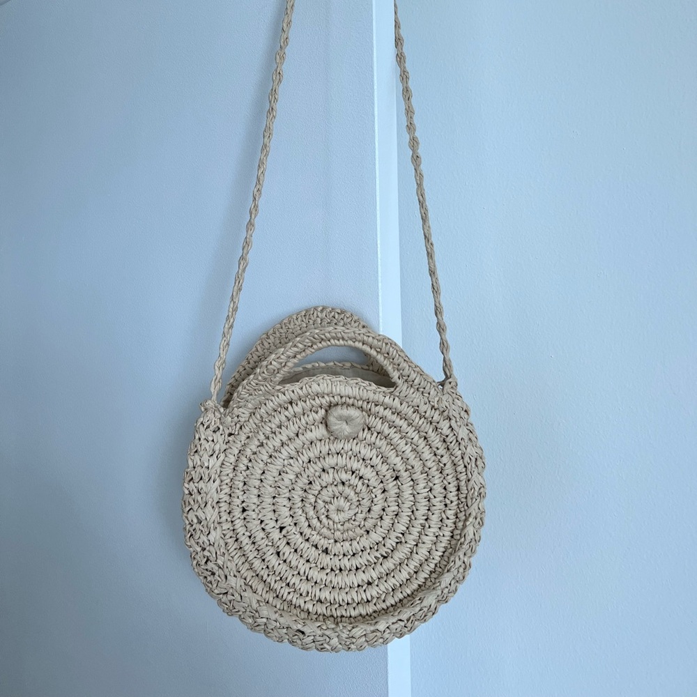 Stylish Cream Woven Round Bag with shoulder strap.